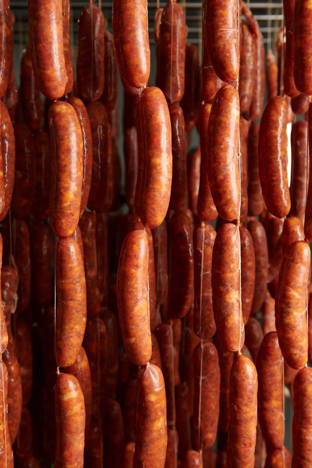 Cured sausages hanging on the rack